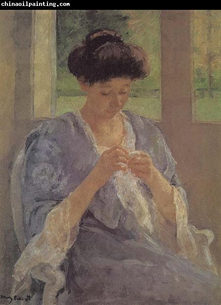 Mary Cassatt lady is sewing in front of the window