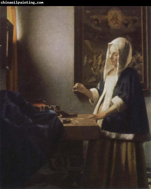 Jan Vermeer woman holding a balance