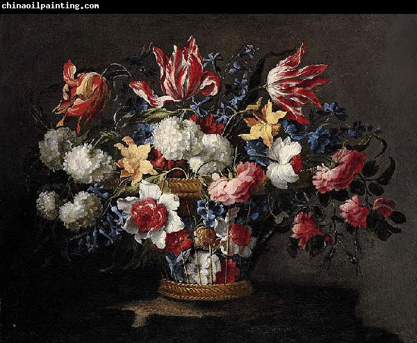 Juan de Arellano roses and other flowers in a wicker basket on a ledge